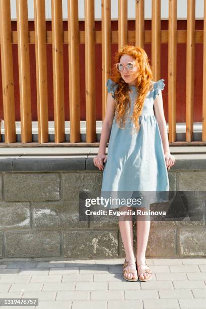 red-haired girl for a walk - curly red hair glasses stock pictures, royalty-free photos & images