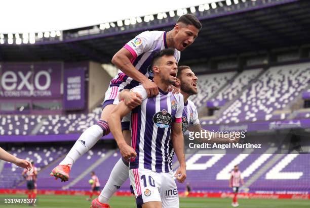 Oscar Plano of Real Valladolid celebrates with team mates after scoring their side's first goal during the La Liga Santander match between Real...