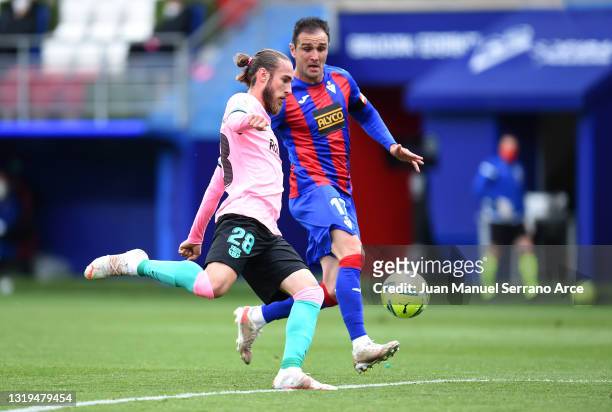 Oscar Mingueza of FC Barcelona battles for possession with Kike of SD Eibar during the La Liga Santander match between SD Eibar and FC Barcelona at...
