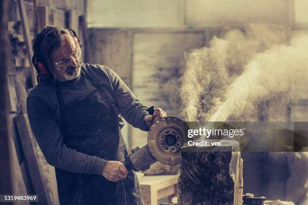 stonemason cutting a rock with a circular saw - stone stock pictures, royalty-free photos & images