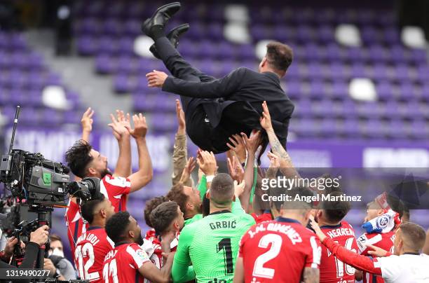 Diego Simeone, Head Coach of Atletico de Madrid is thrown in the air by his players as they celebrate winning the La Liga Santander title after...