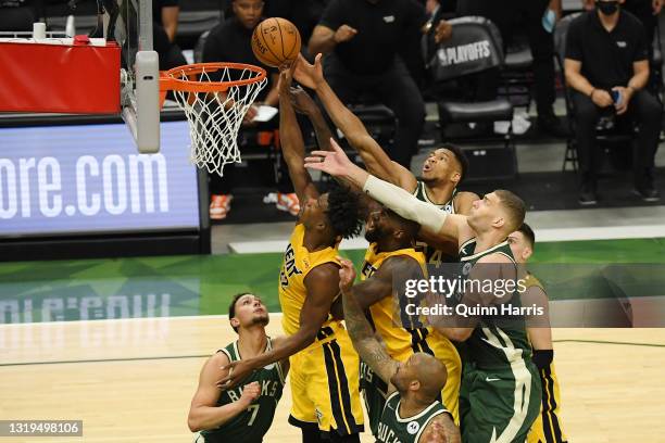 Jimmy Butler of the Miami Heat shoots in the second quarter against Giannis Antetokounmpo of the Milwaukee Bucks during Game 1 of their Eastern...