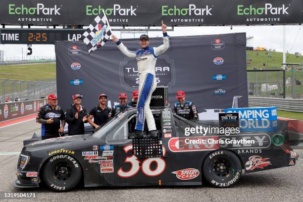 Todd Gilliland, driver of the Crosley Brands Ford, and crew celebrate in victory lane after winning the NASCAR Camping World Truck Series Toyota...