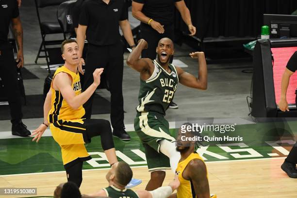 Khris Middleton of the Milwaukee Bucks reacts after scoring in overtime against Duncan Robinson of the Miami Heat during Game 1 of their Eastern...