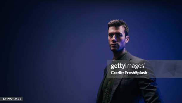 portrait of a serious caucasian man dressed in suit (studio shot) - black shirt stock pictures, royalty-free photos & images