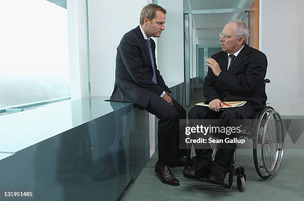 German Finance Minister Wolfgang Schaeuble and Health Minister Daniel Bahr chat upon their arrival for the weekly German government cabinet meeting...
