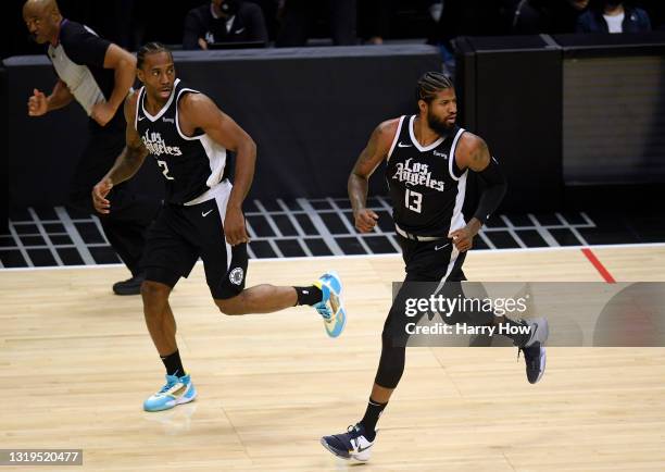 Paul George and Kawhi Leonard of the LA Clippers runs back on defense in the third quarter against the Dallas Mavericks during game one of the...