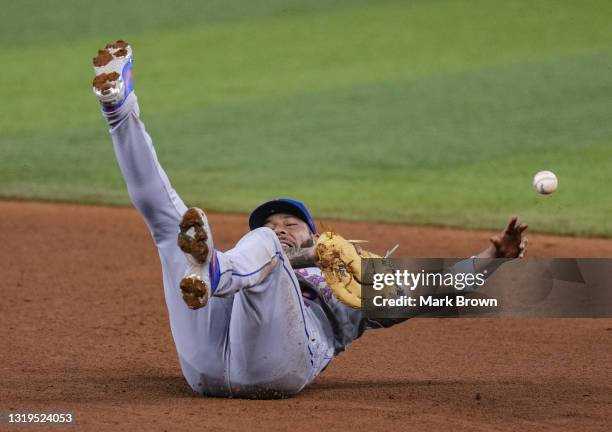 Dominic Smith of the New York Mets fields the ball hit from Miguel Rojas of the Miami Marlins in the eighth inning at loanDepot park on May 22, 2021...