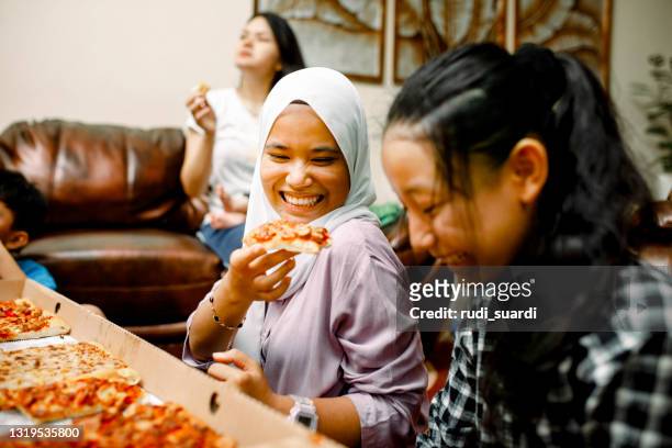 family party at home with pizza - indian family dinner table stock pictures, royalty-free photos & images