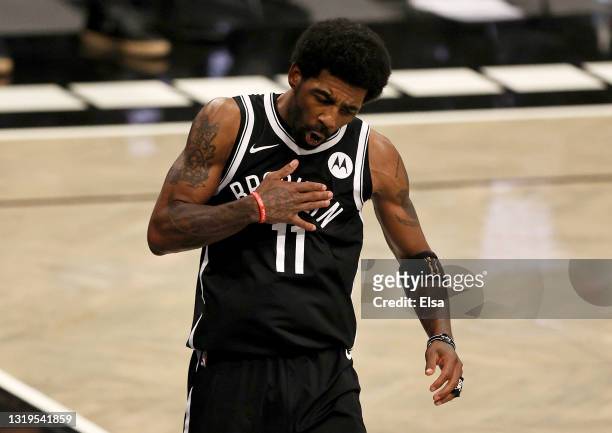 Kyrie Irving of the Brooklyn Nets celebrates after he was fouled by Marcus Smart of the Boston Celtics in the fourth quarter during Game One of their...