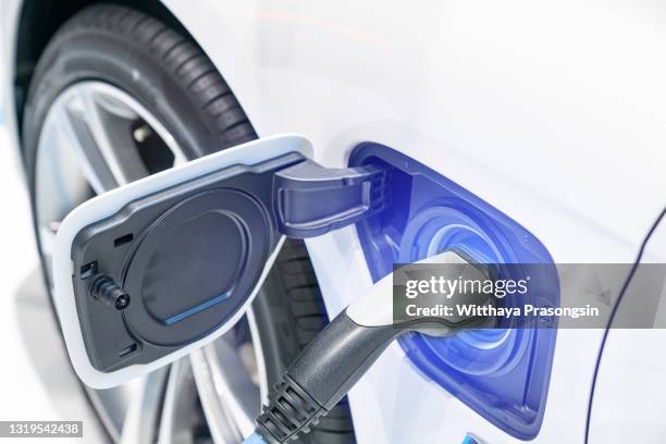 charging an electric car battery - fleet of vehicles stock pictures, royalty-free photos & images