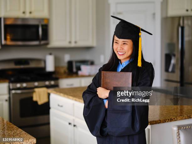 adult graduate celebrating - graduation gown stock pictures, royalty-free photos & images