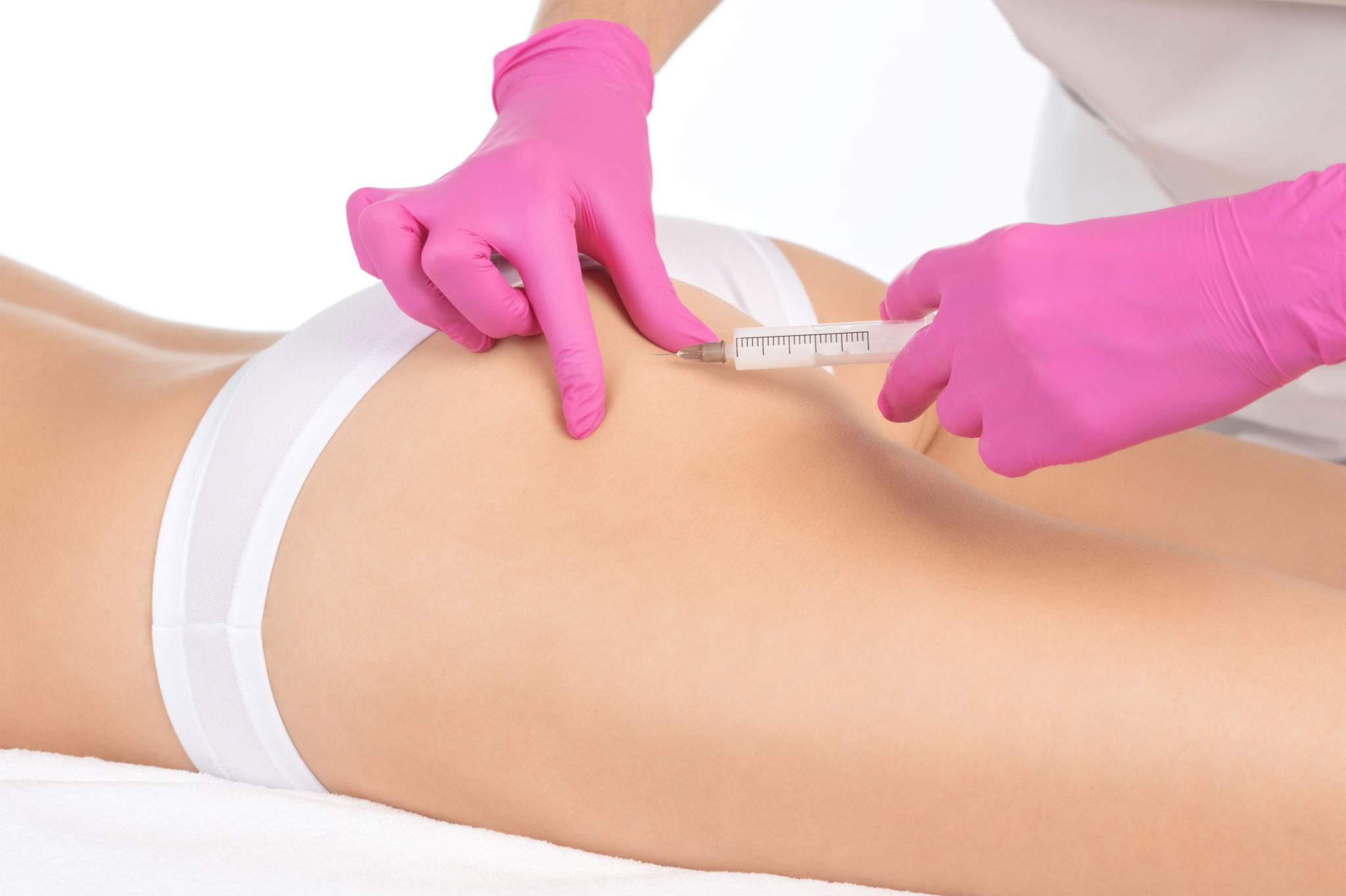 Aesthetic cosmetologist makes lipolytic injections to burn fat on the thighs, hips and body of a woman. Female aesthetic cosmetology in a beauty salon.Cosmetology concept. Aesthetic cosmetologist makes lipolytic injections to burn fat on the thighs, hips and body of a woman. Female aesthetic cosmetology in a beauty salon.Cosmetology concept.