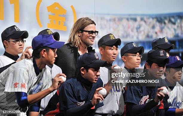 Actor Brad Pitt and young baseball players from the stricken area of the March 11 earthquake and tsunami disaster, pose for a photo during the Japan...