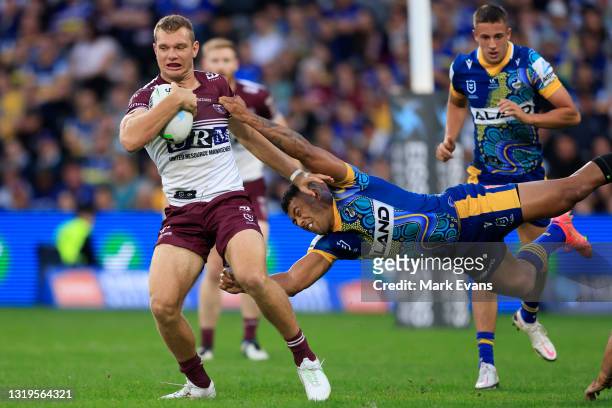 Tom Trbojevic of Manly is tackled by Waqa Blake of the Eels during the round 11 NRL match between the Parramatta Eels and the Manly Sea Eagles at...