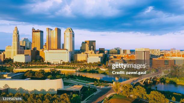 aerial view of downtown columbus ohio with scioto river during sunset - columbus ohio aerial stock pictures, royalty-free photos & images