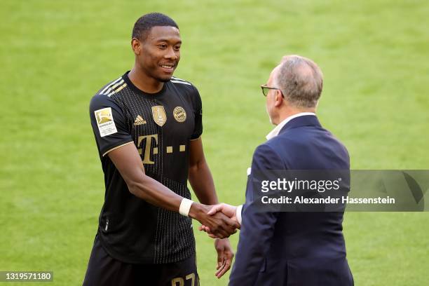 David Alaba of FC Bayern Muenchen reacts with Karl-Heinz Rummenigge, CEO of FC Bayern Muenchen prior to the Bundesliga match between FC Bayern...