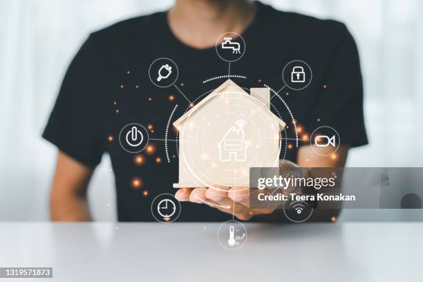 man using a smart home control system with application that controls home electronics - internet delle cose foto e immagini stock
