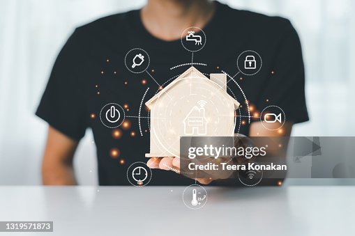 Man using a smart home control system with application that controls home electronics Man using a smart home control system with application that controls home electronics