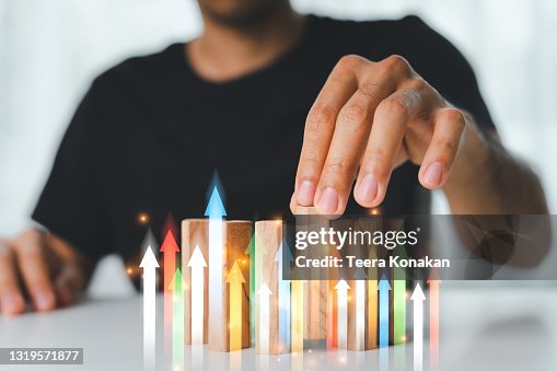 Hand of businessman playing wooden block game. Concept Risk of management and strategy plans for business growth and success. Hand of businessman playing wooden block game. Concept Risk of management and strategy plans for business growth and success.