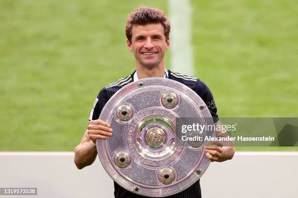 Thomas Mueller of FC Bayern Muenchen lifts the Bundesliga Meisterschale Trophy following the Bundesliga match between FC Bayern Muenchen and FC...