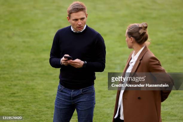 Bastian Wernscheid, team manager of FC Bayern München looks on next to Kathleen Krüger of FC Bayern München after the Bundesliga match between FC...