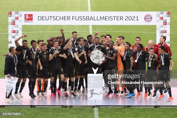 The FC Bayern Muenchen team celebrate with the Bundesliga Meisterschale trophy following the Bundesliga match between FC Bayern Muenchen and FC...