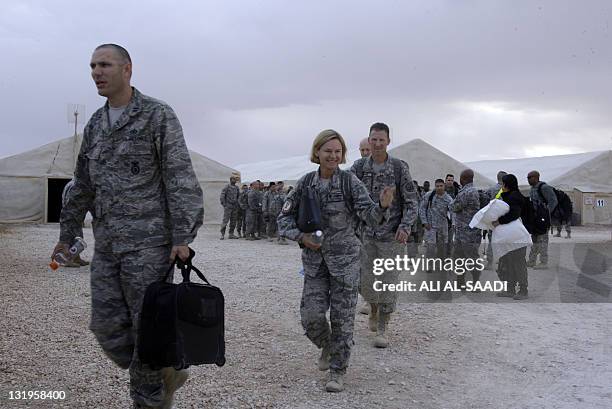 Army soldier waves as her reginment prepares to fly out of Iraq on their way home from the al-Asad Air Base west the capital Baghdad, on November 1,...