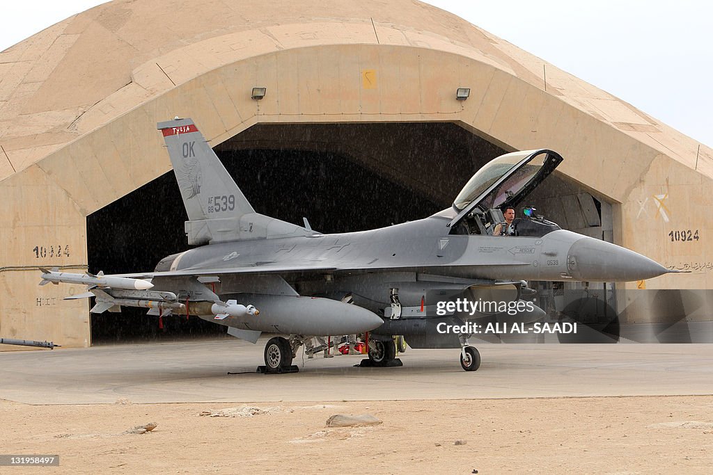 A pilotsits in a US F16 jet fighter at t