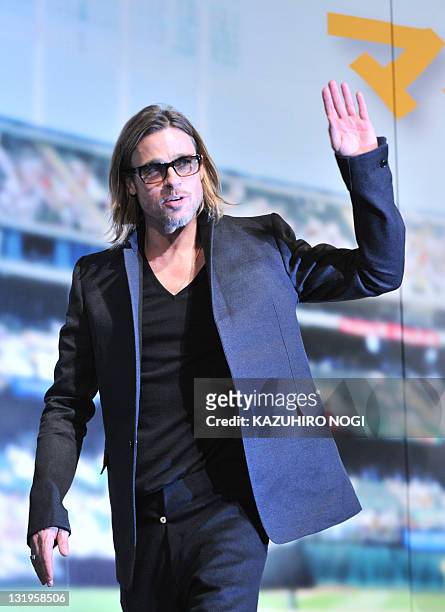 Actor Brad Pitt acknowledges cheering fans during the Japan premiere of his latest film "Moneyball' in Tokyo on November 9, 2011. The film will tour...