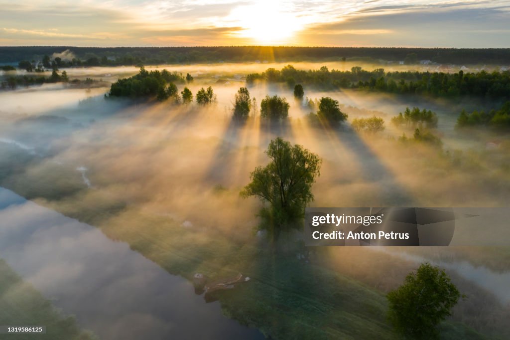 Beautiful misty dawn in the spring on the river. Aerial view
