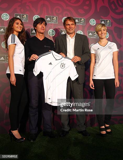 Head coach Joachim Loew and Guenter Weigl of adidas pose with the new Jersey during the Germany national team Euro 2012 jersey launch at Mercedes...