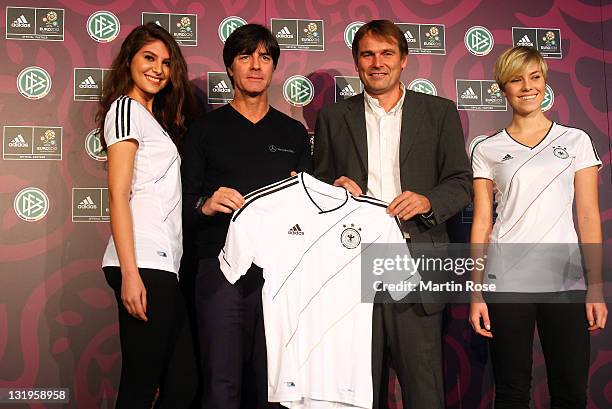 Head coach Joachim Loew and Guenter Weigl of adidas pose with the new Jersey during the Germany national team Euro 2012 jersey launch at Mercedes...