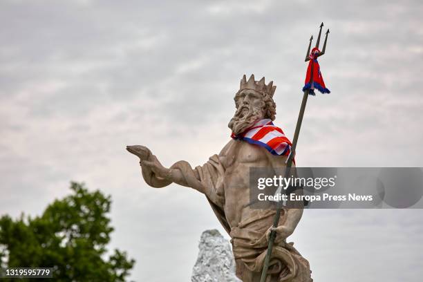 An Atletico Madrid scarf is placed on the statue of the fountain of Neptune following celebrations, on May 23, 2021 in Madrid, Spain.