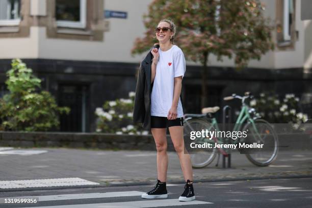 Henrike Schaefer wearing black Stronger biker shorts, white Cricket shirt, black Oh April blazer and black Superga sneakers via The Wants Shoes on...