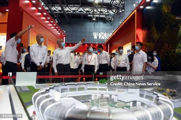 Visitors watch a model of spallation neutron source during 2021 Beijing Science and Technology Week at Zhongguancun Science Park on May 22, 2021 in...