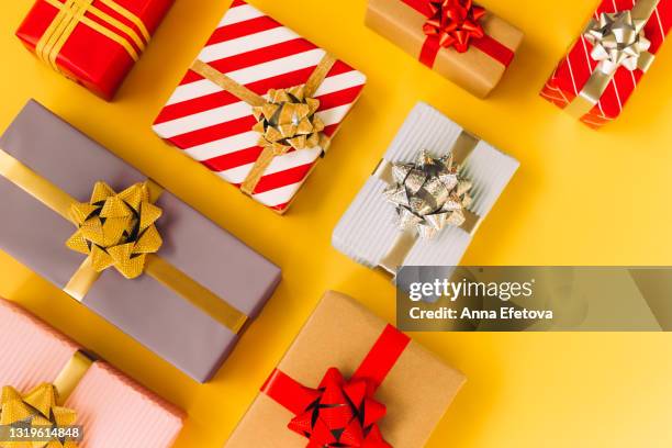 set of various multi colored gift boxes placed on illuminating yellow background with copy space. trendy colors of the year 2021. flat lay style - regalo di compleanno foto e immagini stock