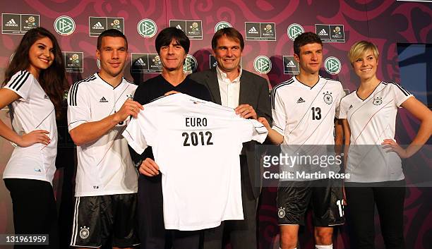 Lukas Podolski, Joachim Loew, Guenter Weigl of adidas and Thomas Mueller pose with the Jersey during the Germany national team Euro 2012 jersey...
