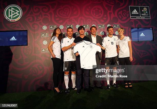 Lukas Podolski, Joachim Loew, Guenter Weigl of adidas and Thomas Mueller pose with the Jersey during the Germany national team Euro 2012 jersey...