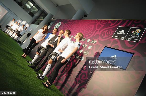 Players model shirts during the German national team Euro 2012 jersey launch at the Mercedes Benz center on November 9, 2011 in Hamburg, Germany.