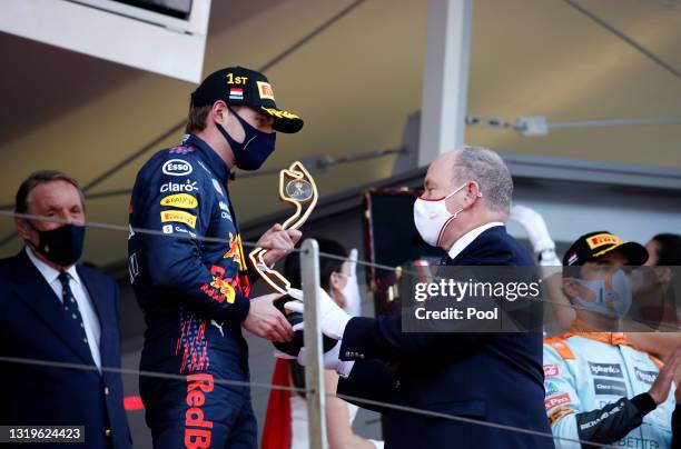 Race winner Max Verstappen of Netherlands and Red Bull Racing receives his trophy from Prince Albert of Monaco on the podium during the F1 Grand Prix...