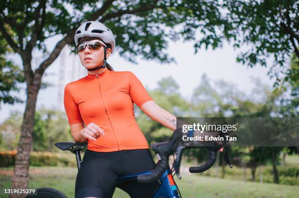 asian chinese female cyclist getting ready at public park with her road bike cycling - cycling vest stock pictures, royalty-free photos & images