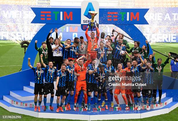 Samir Handanovic of FC Internazionale lifts the Serie A Trophy whilst his team mates celebrate after the Serie A match between FC Internazionale...