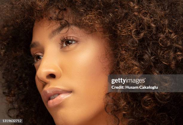 close up view of beautiful woman with brunette and curly hair. - retouched image stock pictures, royalty-free photos & images