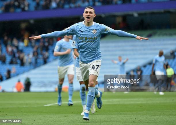 Phil Foden of Manchester City celebrates after scoring their side's third goal during the Premier League match between Manchester City and Everton at...