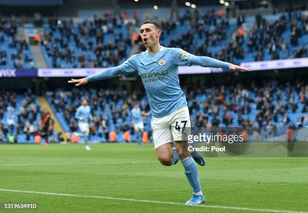 Phil Foden of Manchester City celebrates after scoring his team's third goal during the Premier League match between Manchester City and Everton at...