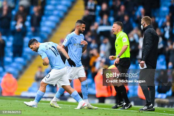 Sergio Aguero of Manchester City greets Riyad Mahrez of Manchester City as Riyad Mahrez is substituted off and Sergio Aguero is substituted on during...