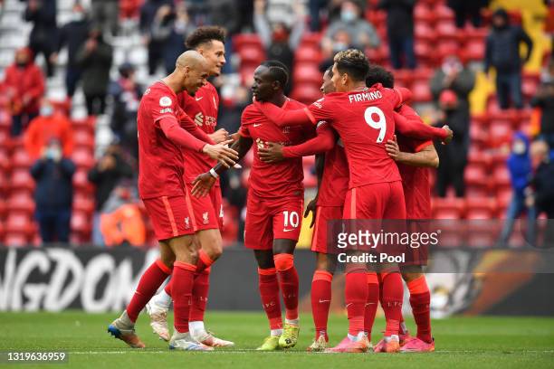 Sadio Mane of Liverpool celebrates with Fabinho and team mates after scoring their side's second goal during the Premier League match between...