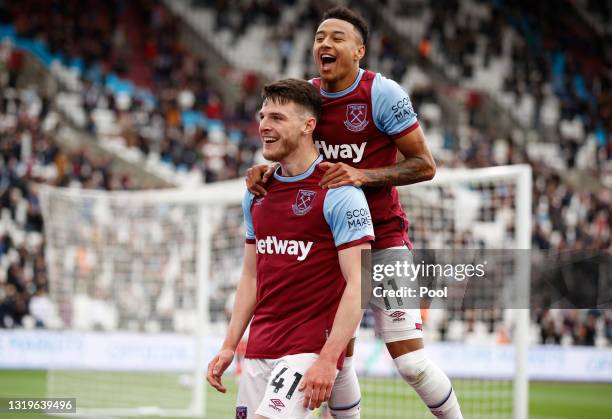 Declan Rice of West Ham United celebrates with team mate Jesse Lingard after scoring his team's third goal during the Premier League match between...