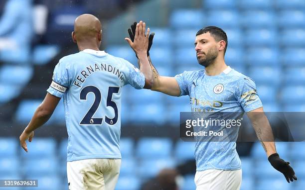 Sergio Aguero of Manchester City celebrates with teammate Fernandinho after scoring his team's fifth goal during the Premier League match between...
